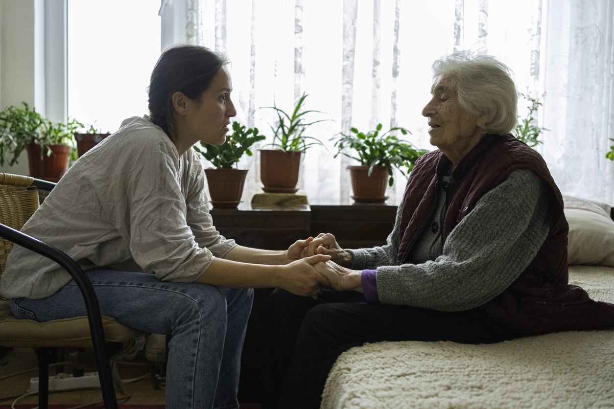 care partner holding hands with elder