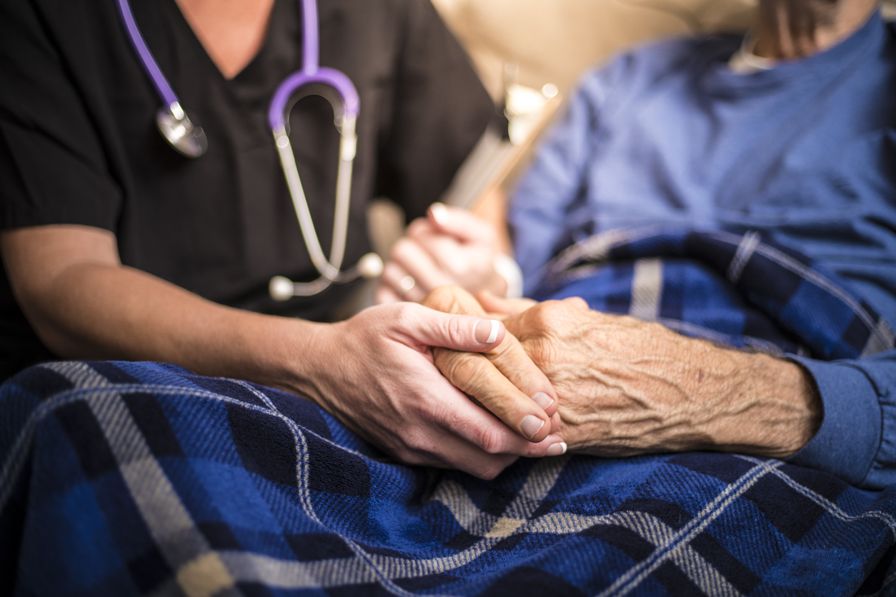 hospice nurse helping older adult